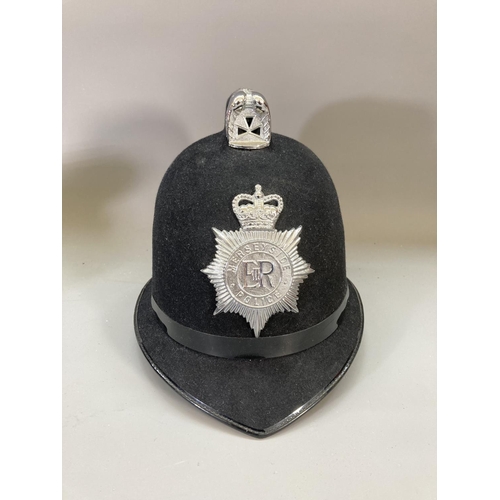 246 - A collection of mid/late 20th century police memorabilia to include four Merseyside Police hats, two... 