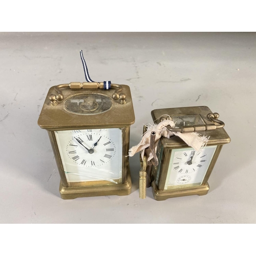 260 - Two early 20th century brass cased key wind carriage clocks - largest approx. 10.5cm high x 8cm wide... 