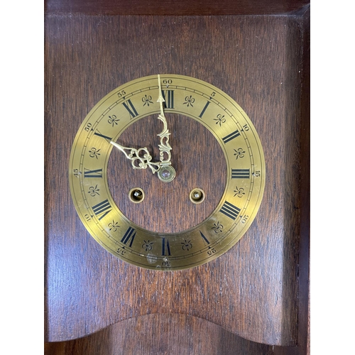 261 - A late 20th century mahogany cased wall clock with pendulum and key - approx. 71cm high x 33cm wide ... 