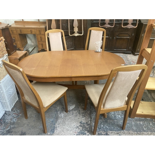 337 - A mid/late 20th century teak twin pedestal extending oval dining table and six beech and beige uphol... 