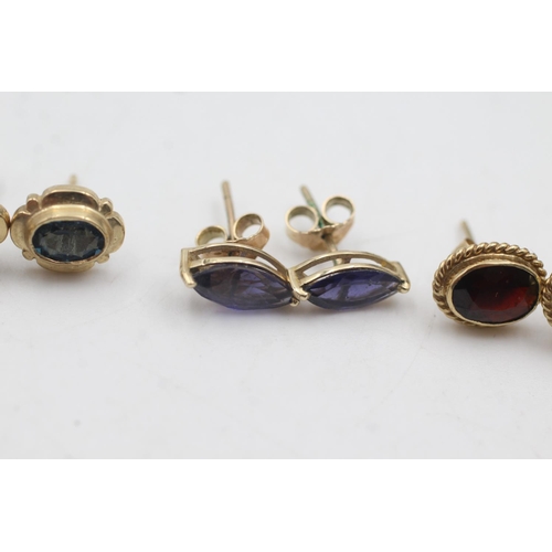 1083 - Three pairs of 9ct gold stud earrings, one iolite, one topaz and one garnet - approx. gross weight 5... 