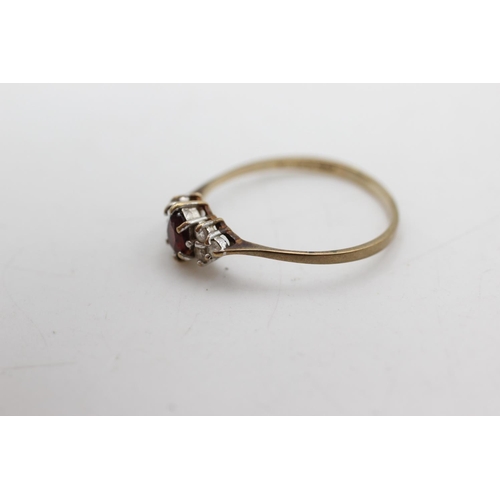 1087 - A 9ct gold garnet and clear gemstone dress ring, size P½ - approx. gross weight 1.1 grams