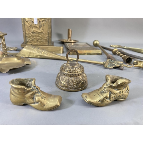 215 - A collection of brassware to include wall mountable letter rack, ashtray, companion set holder etc.