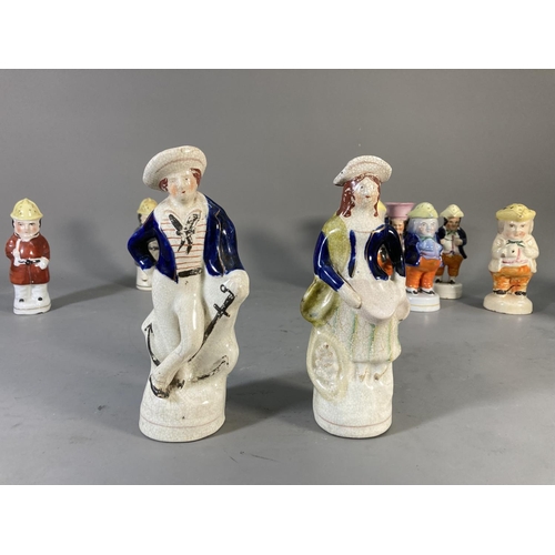 180 - Fifteen 19th century Staffordshire Pottery figures and character cruets