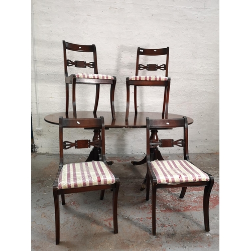 21 - A Regency style mahogany oval extending dining table and four matching chairs