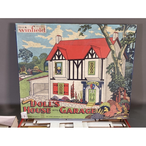 256 - A boxed vintage Winfield Packaway doll's house with garage with further doll's house accessories