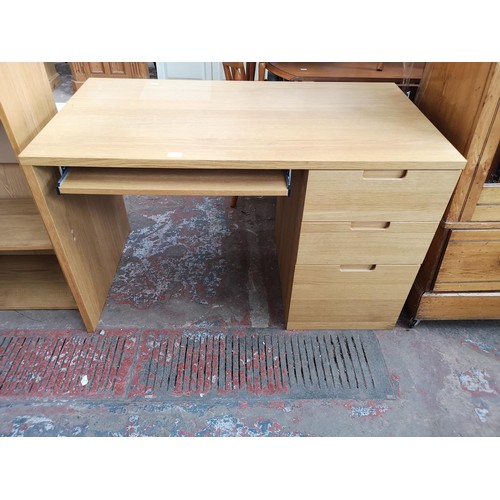 91 - A modern oak effect office desk with three drawers and pull out tray - approx. 74.5cm high x 120cm w... 