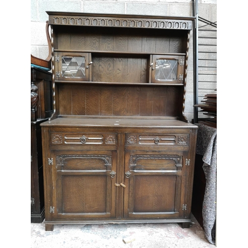 115 - A mid/late 20th century oak Welsh dresser with two upper leaded glass doors, two drawers and two low... 