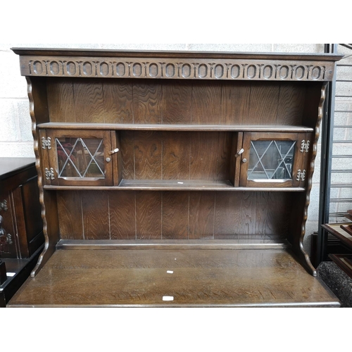 115 - A mid/late 20th century oak Welsh dresser with two upper leaded glass doors, two drawers and two low... 