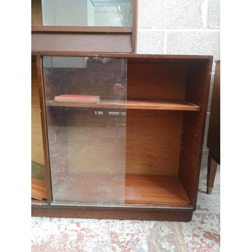120 - Two mid 20th century tola wood bookcases with glass sliding doors, one approx. 84cm high x 76cm wide... 