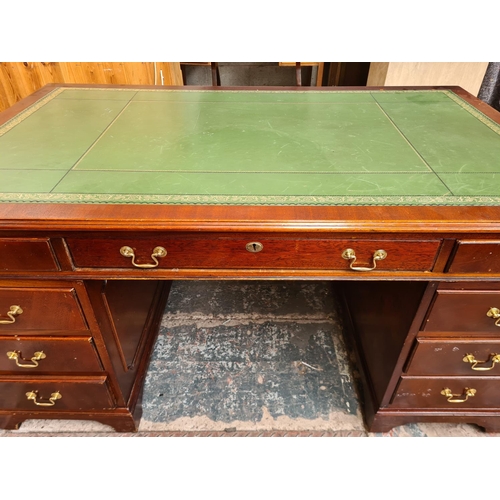 102 - A 19th century style mahogany pedestal desk with green leather writing surface and brass swan neck h... 