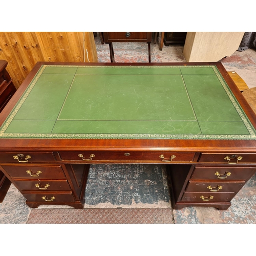 102 - A 19th century style mahogany pedestal desk with green leather writing surface and brass swan neck h... 
