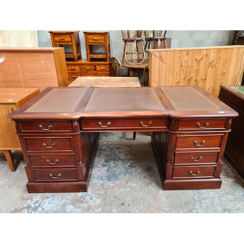 103 - A 19th century style mahogany partners desk with eleven drawers, two cupboard doors and brown leathe... 