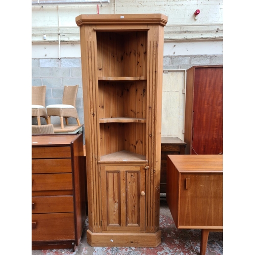 105 - A modern solid pine freestanding corner cabinet with two upper shelves and one lower cupboard door -... 
