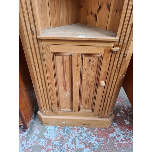 105 - A modern solid pine freestanding corner cabinet with two upper shelves and one lower cupboard door -... 