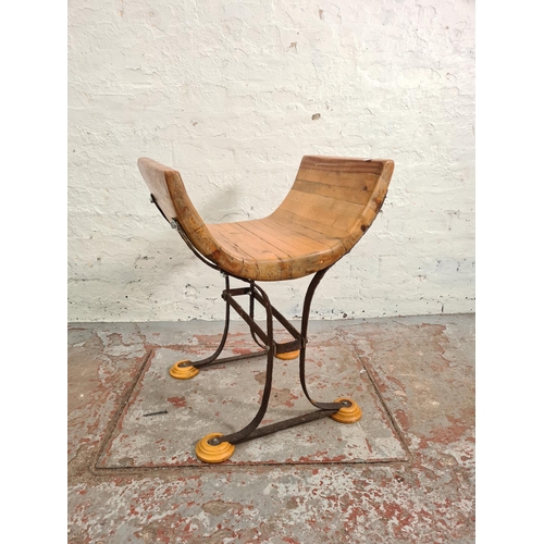 107 - A modern solid pine and wrought iron Savonarola type stool - approx. 67cm high x 52cm wide x 42cm de... 
