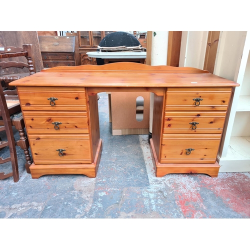 14 - A modern pine dressing table with six drawers - approx. 83cm high x 144cm wide x 43cm deep