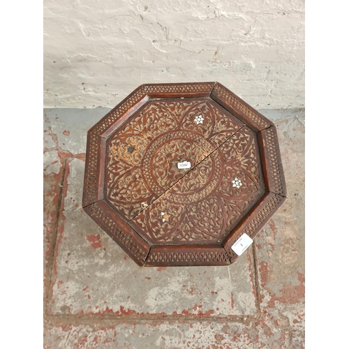 2 - An Anglo-Indian carved teak and mother of pearl inlaid octagonal side table - approx. 52cm high x 38... 