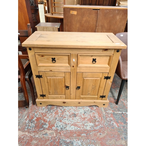 20 - A Mexican pine sideboard with two drawers and two lower cupboard doors - approx. 84cm high x 92cm wi... 