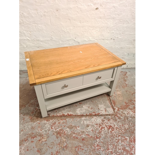 34 - A modern oak and dove grey painted rectangular coffee table with single drawer - approx. 44cm high x... 