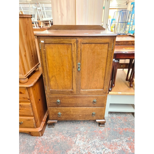 35 - A mid 20th century mahogany cabinet with two upper doors and two lower drawers - approx. 125cm high ... 