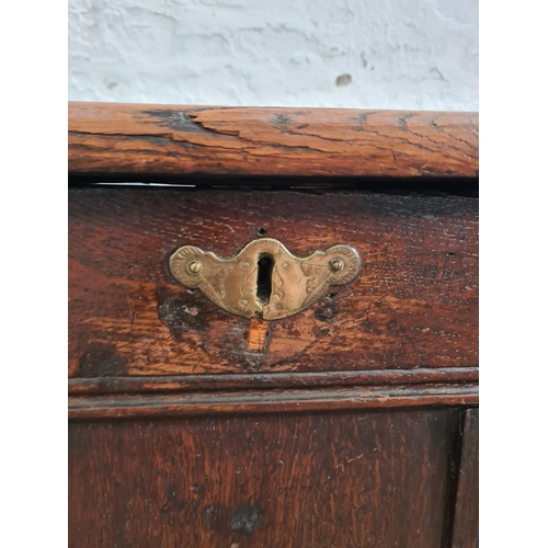 6 - An 18th century oak three panel coffer - approx. 63cm high x 121cm wide x 51cm deep