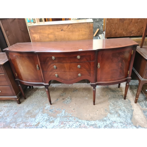71 - A Regency style mahogany serpentine sideboard with three central drawers and two outer cupboard door... 