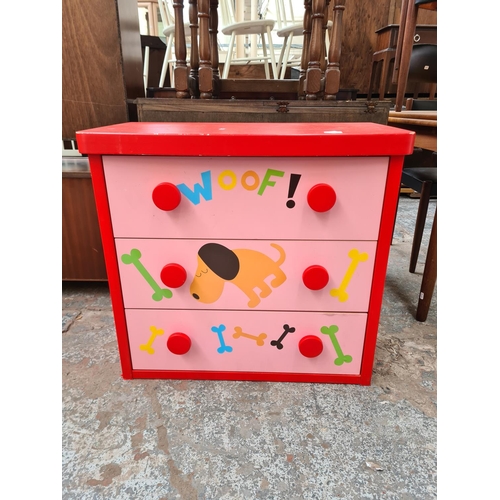84 - A modern red and pink plastic child's chest of three drawers with dog design - approx. 69cm high x 7... 