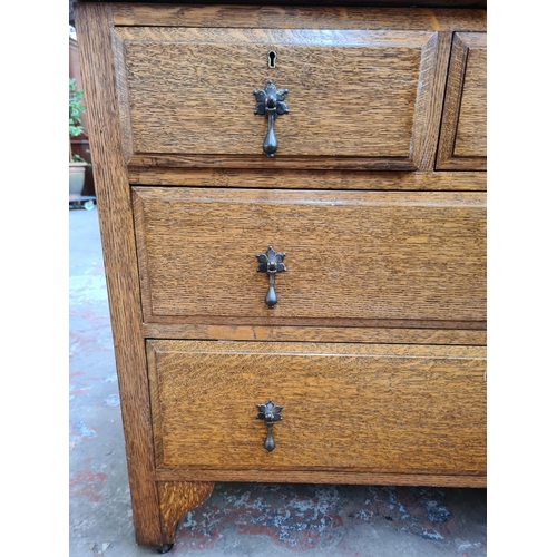 92 - An Arts & Crafts oak dressing chest with two short drawers, two long drawers and upper bevelled edge... 