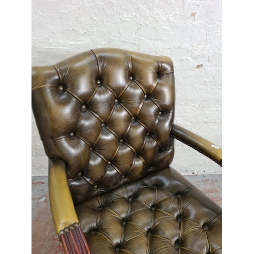 98 - A Chesterfield style green leather and mahogany swivel desk chair - approx. 92cm high x 56cm wide x ... 