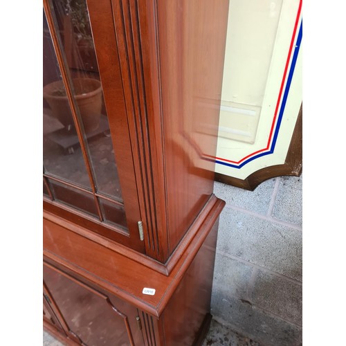 122 - A Georgian style mahogany display cabinet with three upper glazed doors and three lower cupboard doo... 
