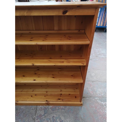 82A - A modern pine four tier open bookcase - approx. 138cm high x 151cm wide x 39.5cm deep