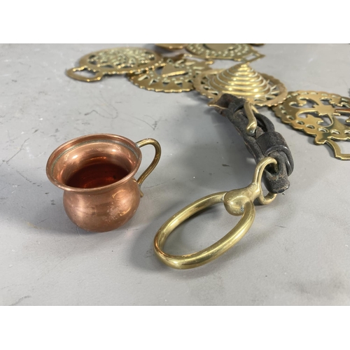 228 - A collection of copper and brassware to include horse brasses, miniature jug etc.