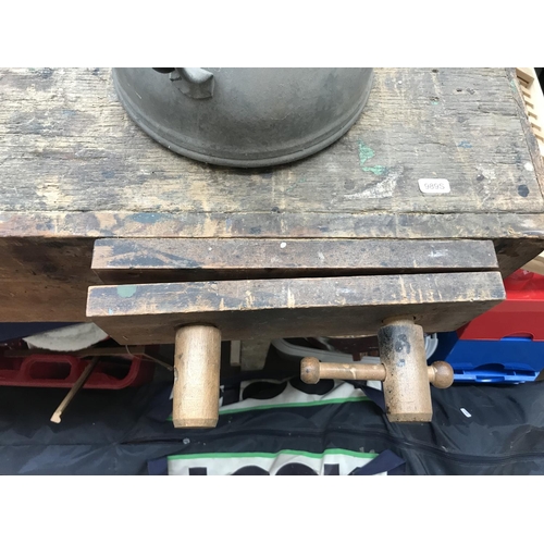 674 - A vintage work bench with wooden vice, galvanised watering can and two extension leads