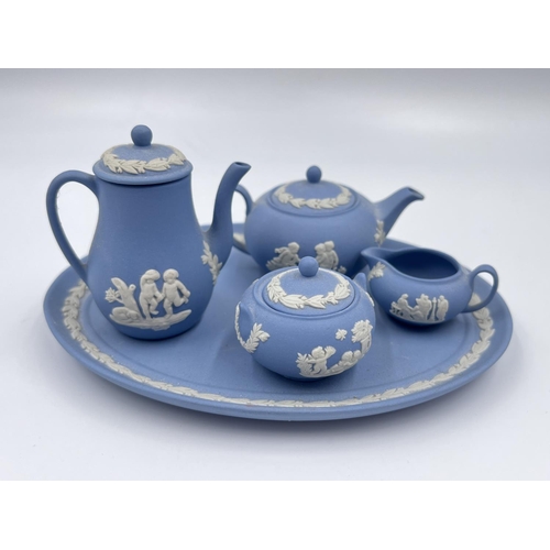 1326 - A Wedgwood pale blue Jasperware five piece miniature tea and coffee set