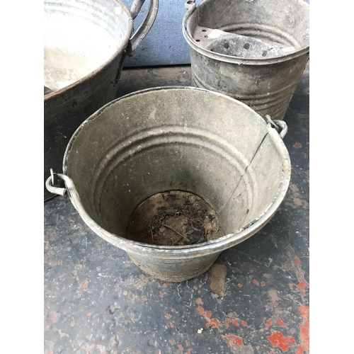 677 - Five items, two galvanised buckets, one galvanised twin handled tub - approx. 89cm wide, one Beldray... 