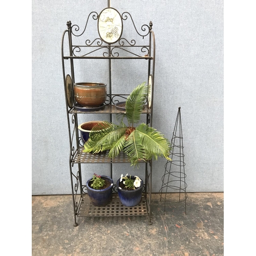 683 - A wrought iron four tier garden shelving unit with ceramic oval plaques and various planters - appro... 