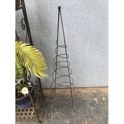 683 - A wrought iron four tier garden shelving unit with ceramic oval plaques and various planters - appro... 