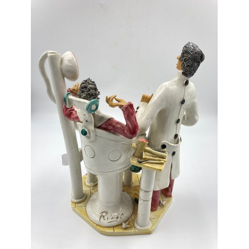 1330A - An Italian hand made ceramic figurine of a dentist and patient - approx. 26cm high