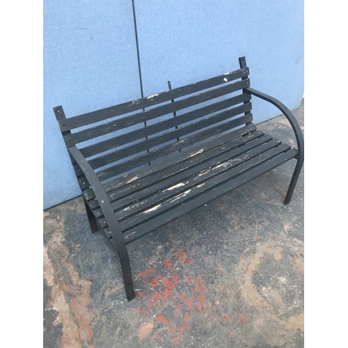 691 - A metal and wooden slatted two seater garden bench - approx. 80cm high x 122cm long x 52cm deep