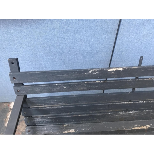 691 - A metal and wooden slatted two seater garden bench - approx. 80cm high x 122cm long x 52cm deep