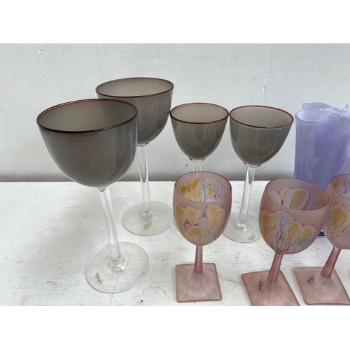 180A - A collection of studio glass to include four Simron hand painted 16cm wine glasses, John Lewis purpl... 