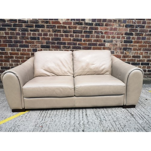 25B - A modern beige leather three seater sofa - approx. 210cm wide x 98cm high x 98cm deep