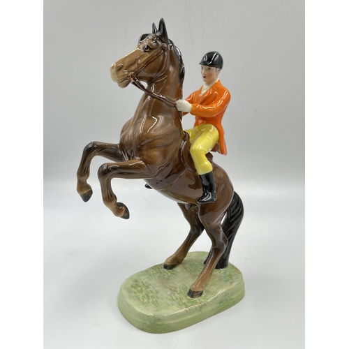 2 - A Beswick Huntsman On Rearing Horse figurine with orange jacket and yellow jodhpurs - approx. 25cm h... 