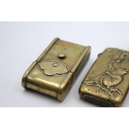 1340 - Four vintage smoking accessories comprising two brass vesta cases, brass cigar cutter and Scarboroug... 