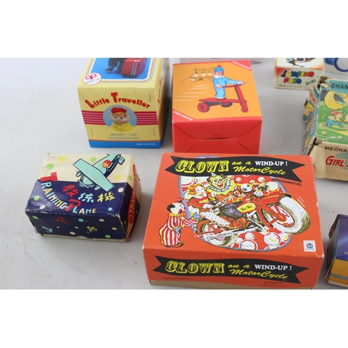 225 - Ten boxed vintage tinplate and clockwork toys to include clown, car, plane etc.