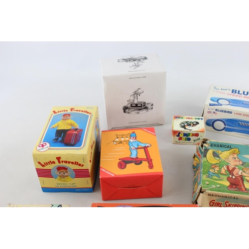 225 - Ten boxed vintage tinplate and clockwork toys to include clown, car, plane etc.