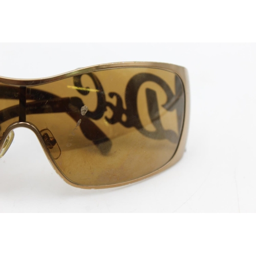 275 - A pair of women's Dolce & Gabbana bronze oversized 00's style sunglasses with brown lenses