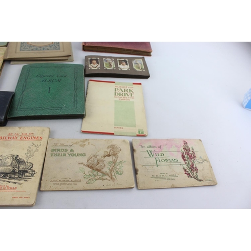 295 - A collection of vintage cigarette card albums to include Wills's Roses, Garden Life, Aviation, Crick... 