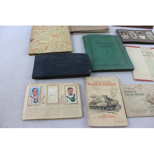 295 - A collection of vintage cigarette card albums to include Wills's Roses, Garden Life, Aviation, Crick... 